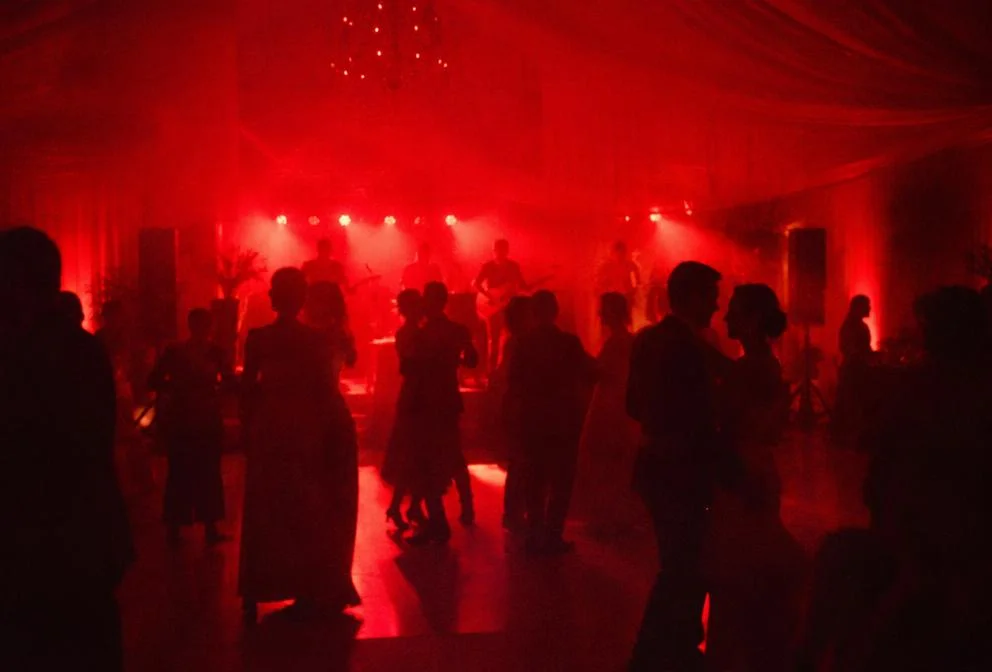 Wedding reception dance floor with red uplighting