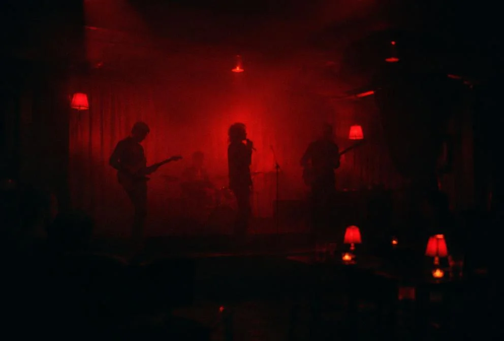 Small stage in a moody red-lit lounge