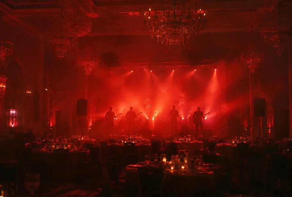 Ballroom stage with red lights and a band