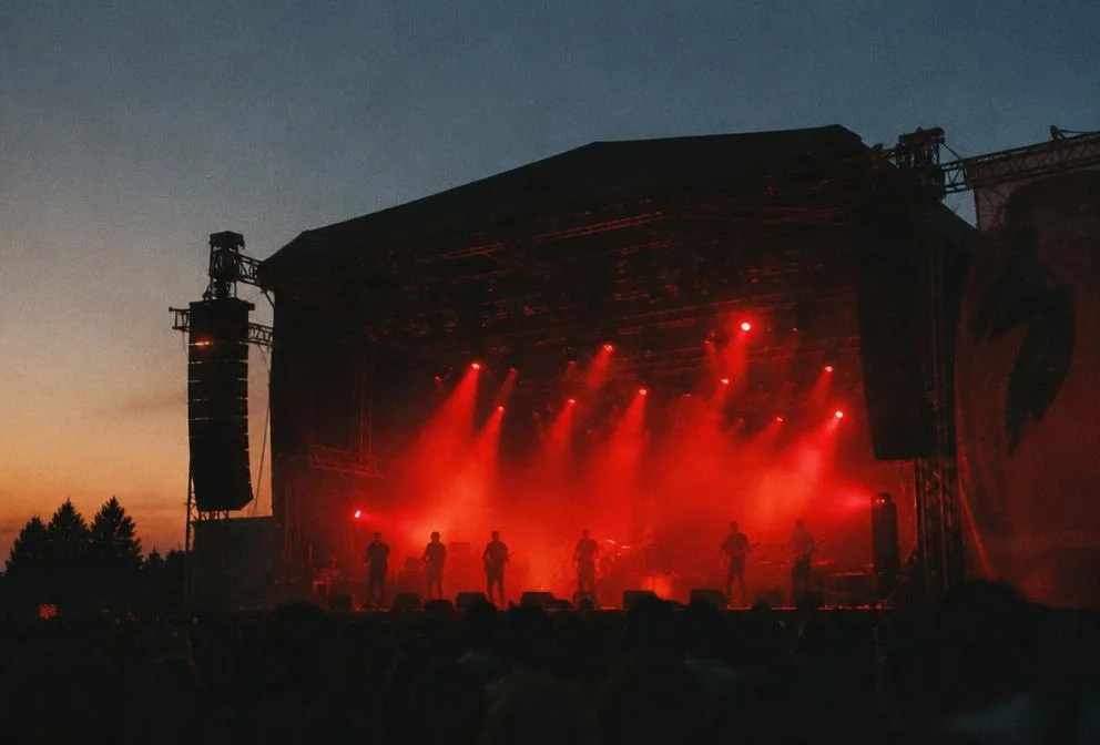 Outdoor stage at dusk with red lights