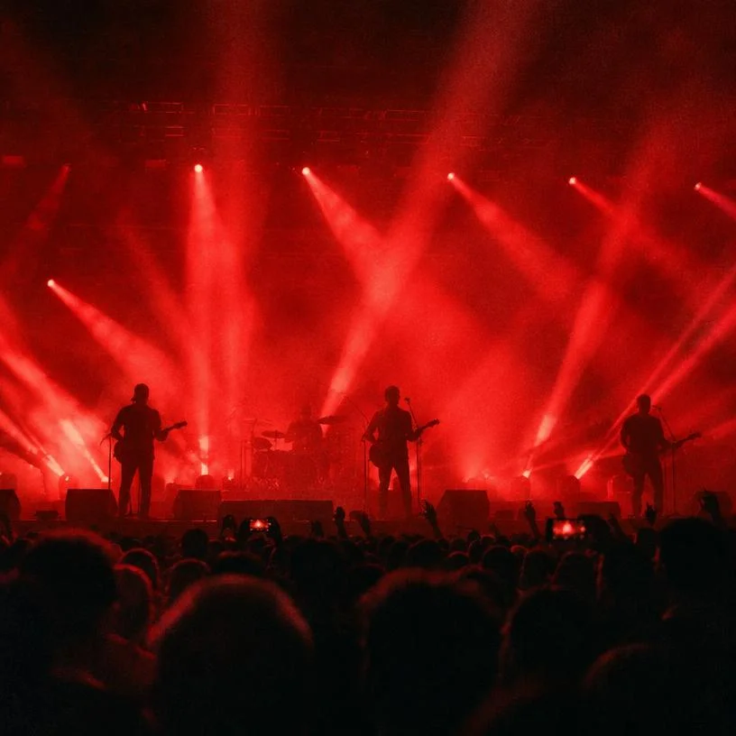 Wide stage shot with red light rays over the crowd